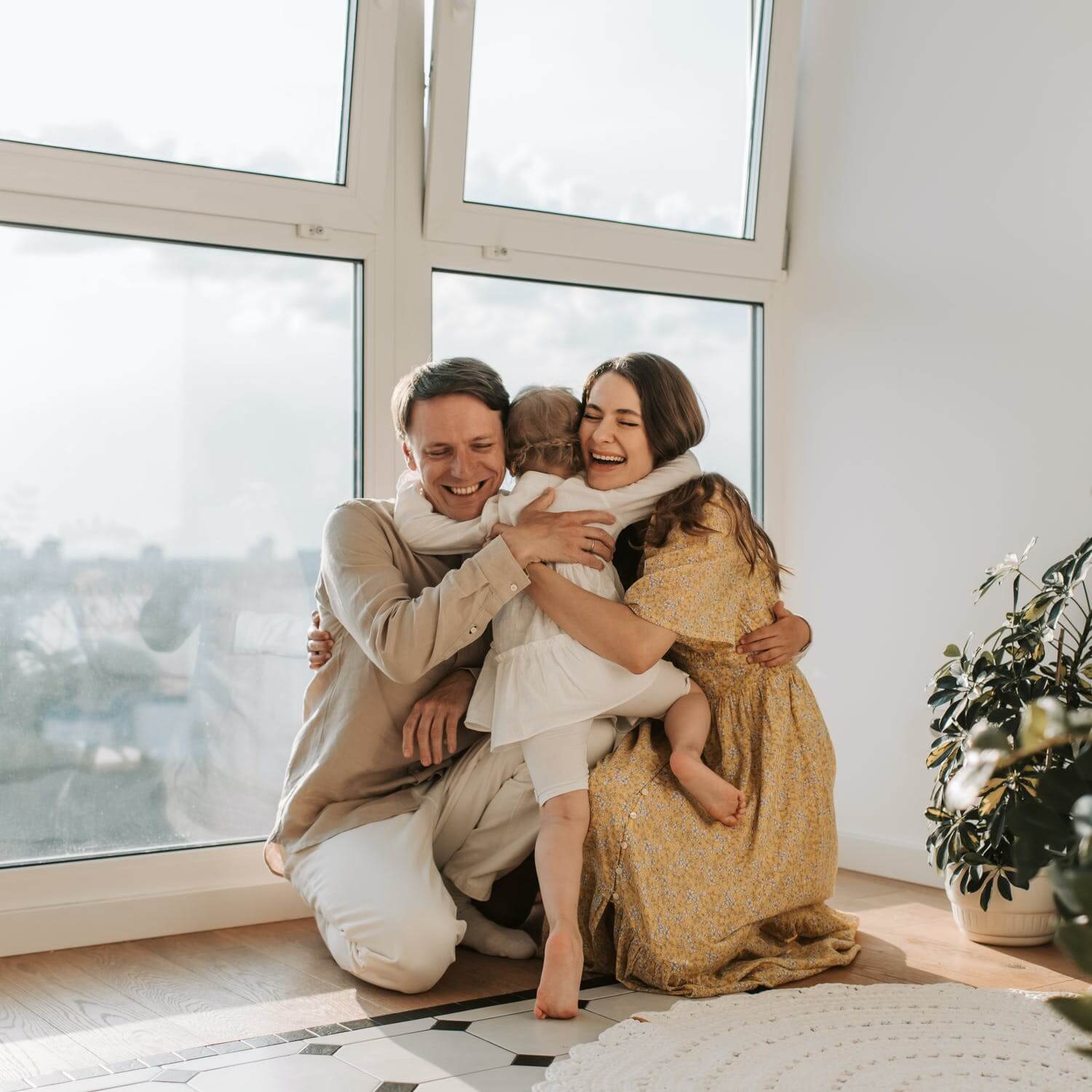 a man and woman holding a baby