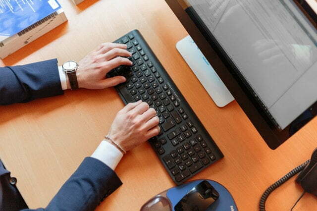 a person typing on a keyboard