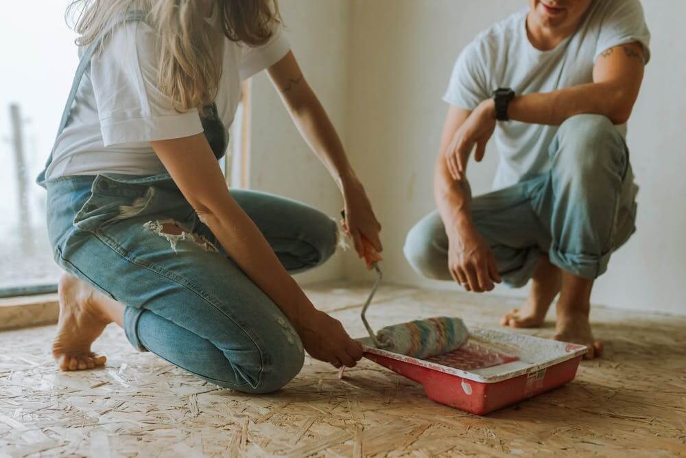 a person using a tool to cut a hole in the floor