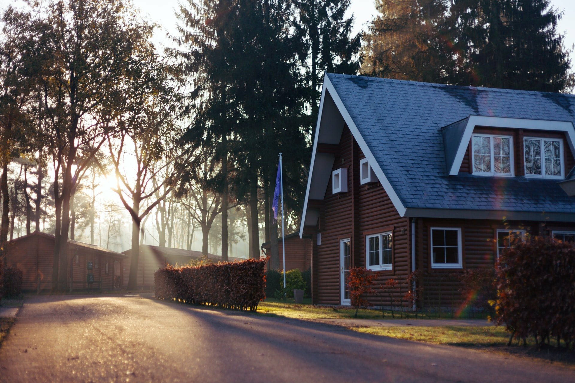 a house with a road and trees around it