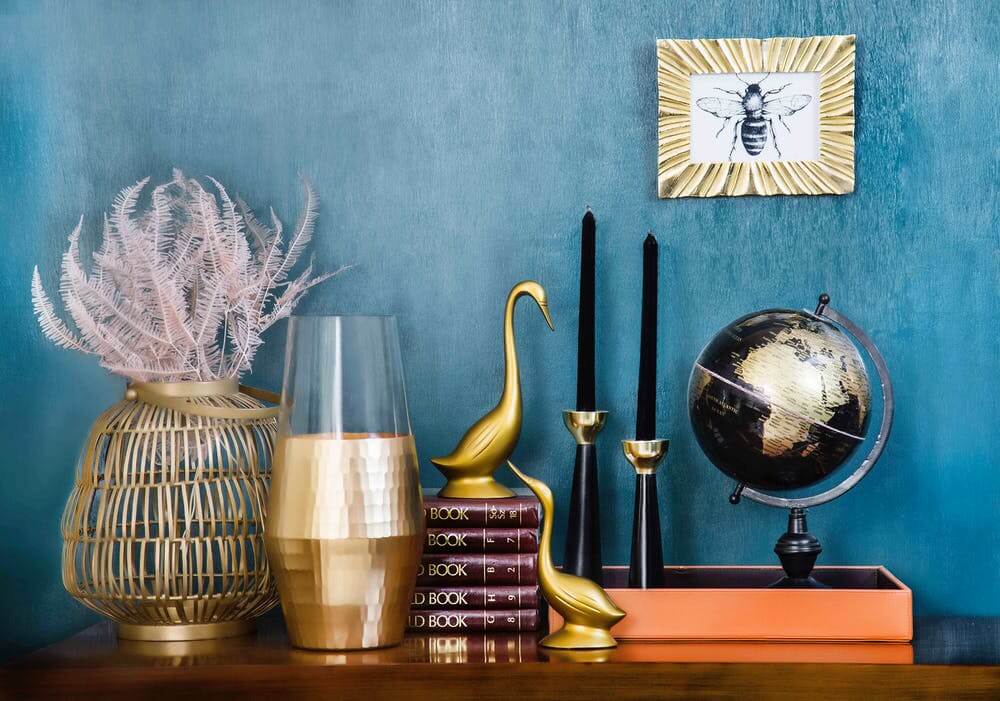 a group of glass vases with a globe on a table