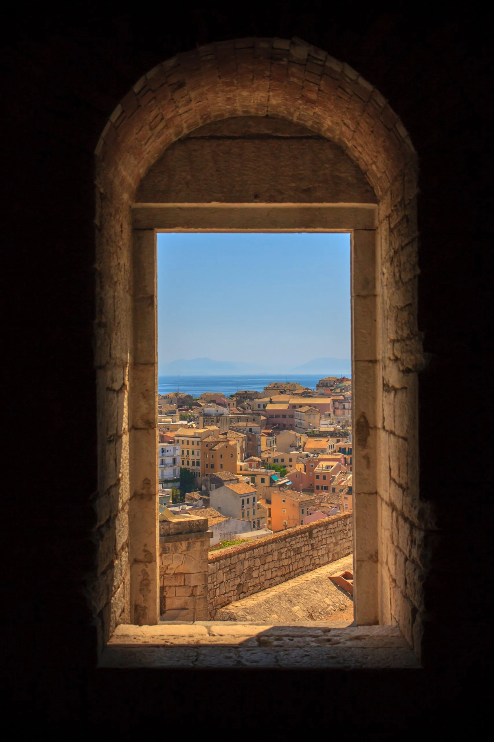a window with a view of the city below