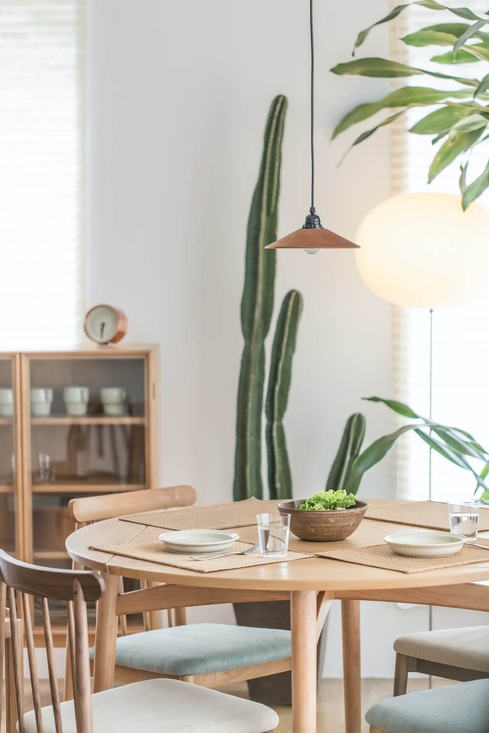 a dining table with a plant on the table