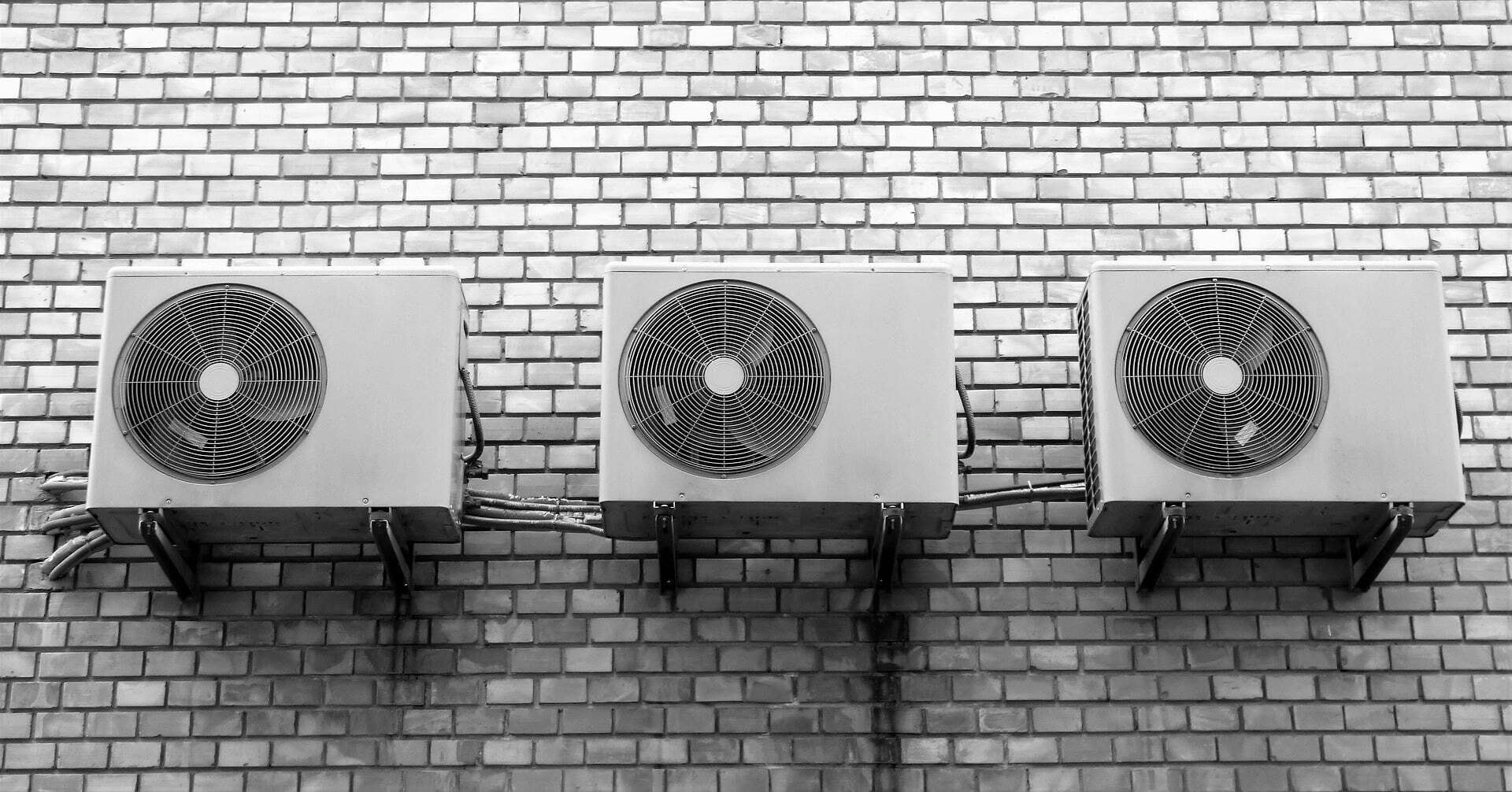 a set of speakers on a brick surface