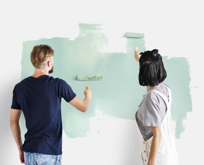 a man and a woman drawing on a white board